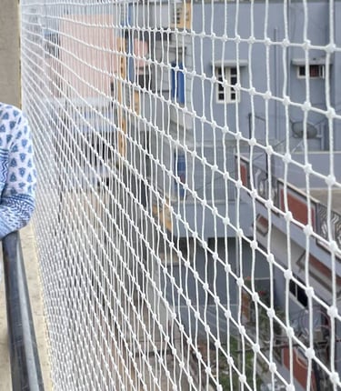 happy customer beside their pigeon net installed balcony in chembur mumbai