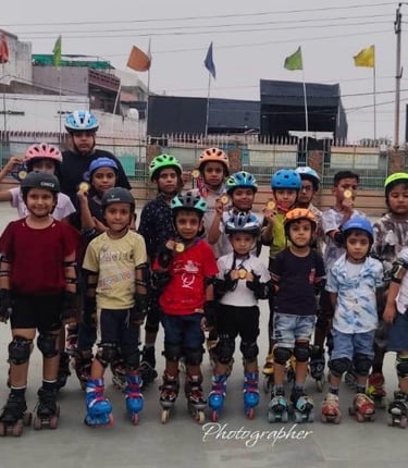 Group of young children wearing helmets and pads during a roller skating class outdoors.