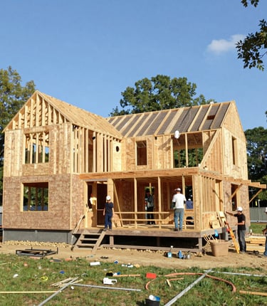 Construction team collaborating on a building site under a bright blue sky in Pennsylvania.