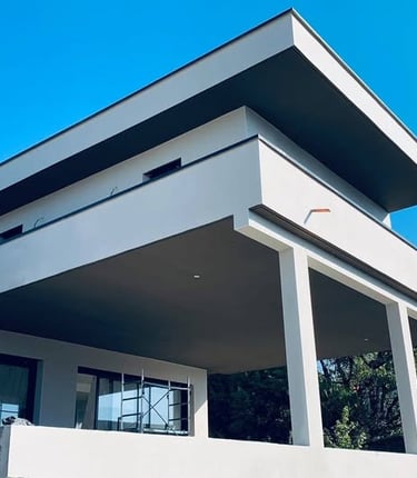 a white house with a large white roof and a large white building