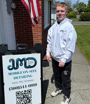 person standin by sign with grass and flag in the background