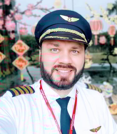 a man in a pilot's uniform is smiling and wearing a pilot's