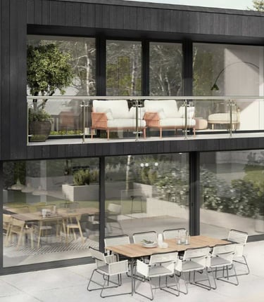 a modern house with a balcony and a table with chairs