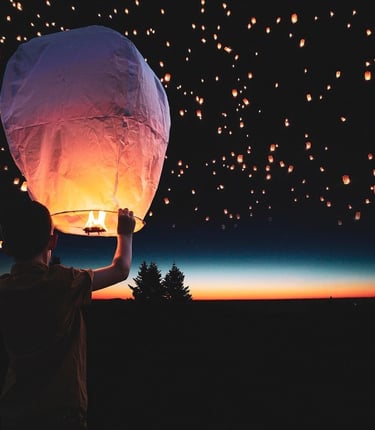 boy-releasing-paper-lantern