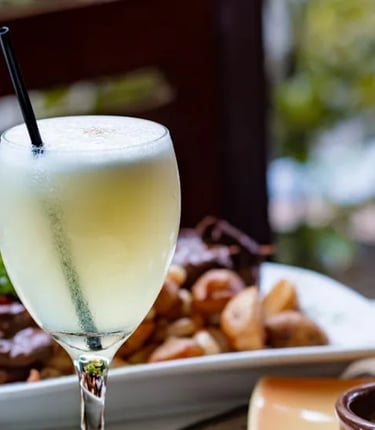 A pisco cocktail with seafood in Peruvian restaurant Lisbon Portugal