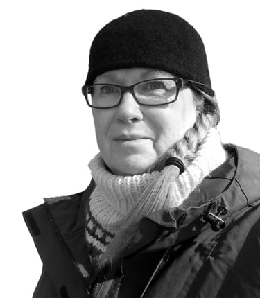 a black and white photo of a woman in a hat