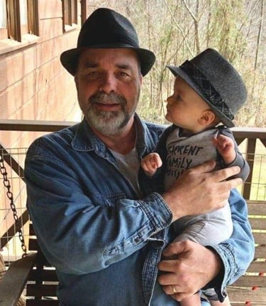 a man in a hat and a hat on a swing
