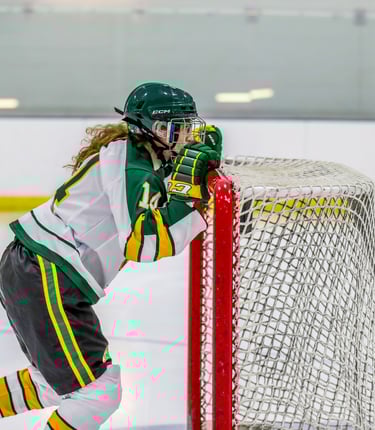 GMU Hockey player pushing a hockey net