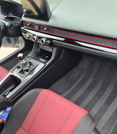 a car dashboard with a steering wheel and a steering wheel