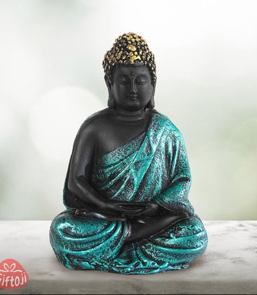 a statue of a buddha statue sitting on a table