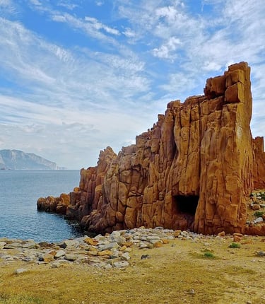 a cave in the middle of a rocky cliff