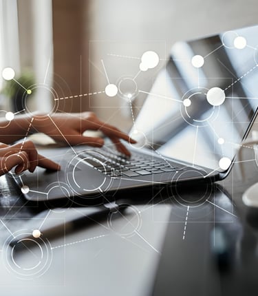 a woman is typing on a laptop computer