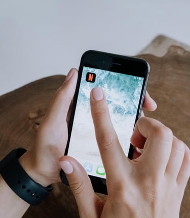 a person holding a cell phone in their hand