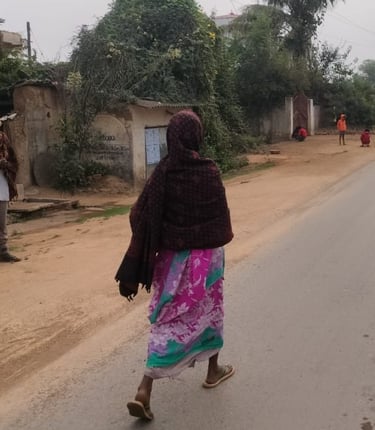 a lady is walking on the road