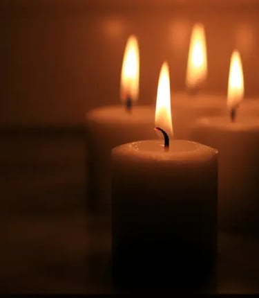 A group of softly glowing candles symbolizes peace, reflection, intuition, and spiritual connection.