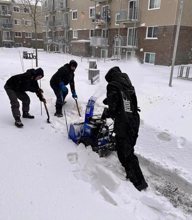 a group of people are shoveling through the snow
