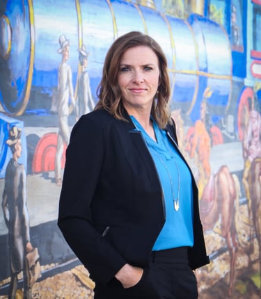 a woman in a blue shirt and black pants