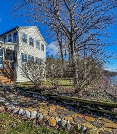 a house with a stone wall and a stone wall