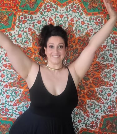 Image of Maria with her hands up with a big smile. The background is a orange and green mandala.