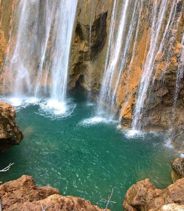 a waterfall in a canyon near a waterfall