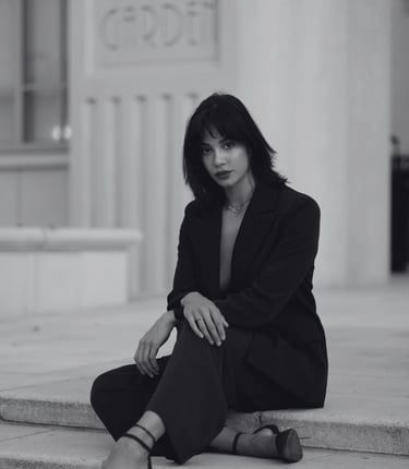 a well dressed woman with high standards wearing heels sitting outside a building