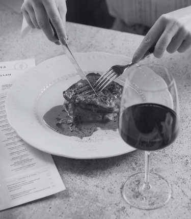 a photo of a woman eating dinner at a piano piano reservation