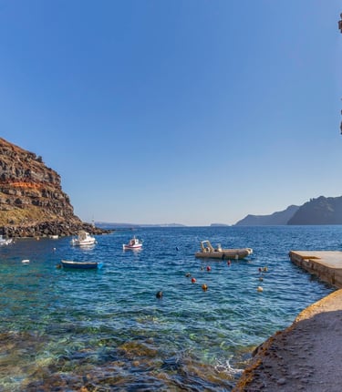a boat in the water near a cliff