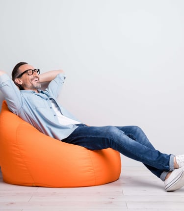a man sitting on a bean bag chair
