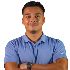 a man in a blue shirt arms folded and smiling