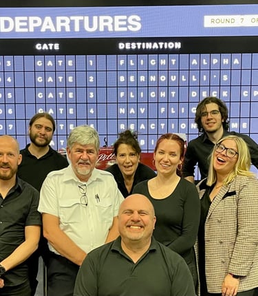people standing in from of an airport board