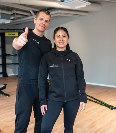 a man and woman standing in a gym