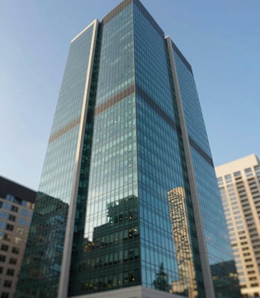 A minimalist, low-angle shot of a modern glass skyscraper in downtown Toronto, reflecting a clear blue sky, incorporating the deep green #00381f and warm cream tones, professional and clean architectural photography.