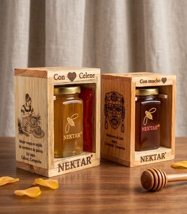 Nektar honey jars in engraved wooden gift boxes with a honey dipper on a wooden table.
