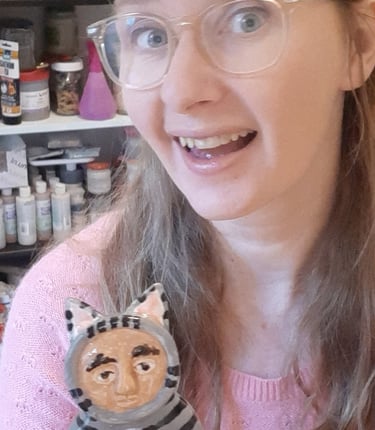 guusje smit creator of the smitties holding a ceramic figurine