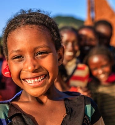 a young child smiling and posing for a picture