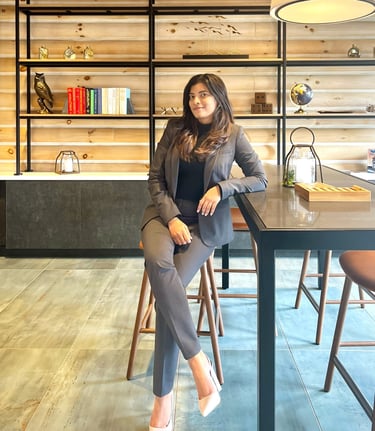 a woman sitting at a table with a lamp on it