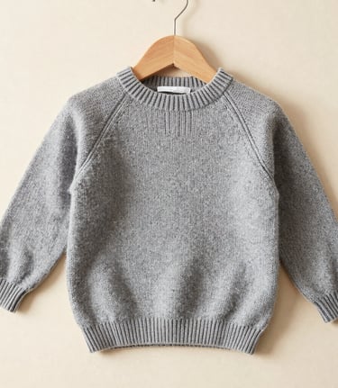 Close-up of soft, high-quality knit fabric in gentle beige tones, highlighting texture and craftsmanship.