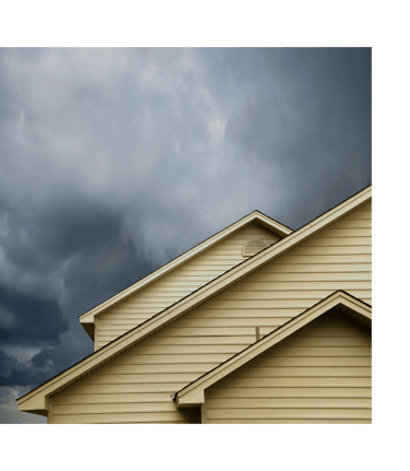 alt="Storm-ready Long Island home exterior showing roof and siding under cloudy sky"