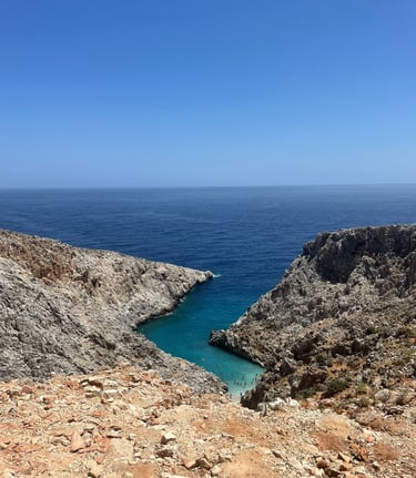 a person standing on a rocky cliff overlooking the ocean