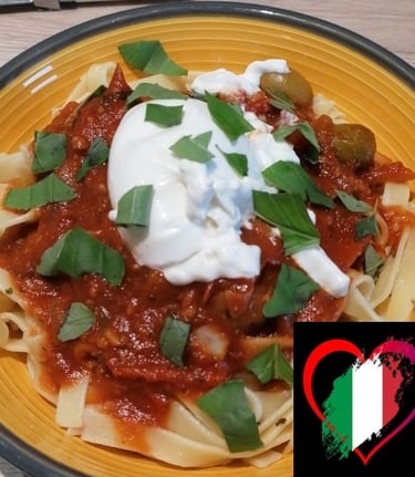 a plate of pasta with a hearty sauce and buffala 