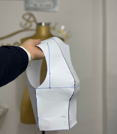 a person holding a piece of paper cut out of a dress