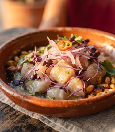 Macro close-up of a perfectly plated modern ceviche, delicate purple corn shoots, cold-pressed lime glaze, warm golden hour side lighting, shallow depth of field, 35mm