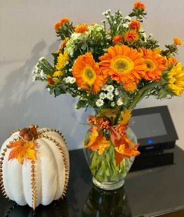 a vase with flowers in a vase on a table