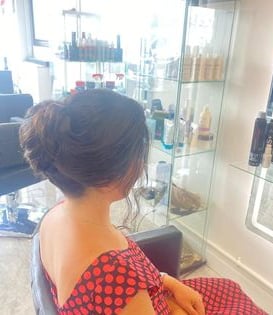 a woman sitting in a chair in Hair salon