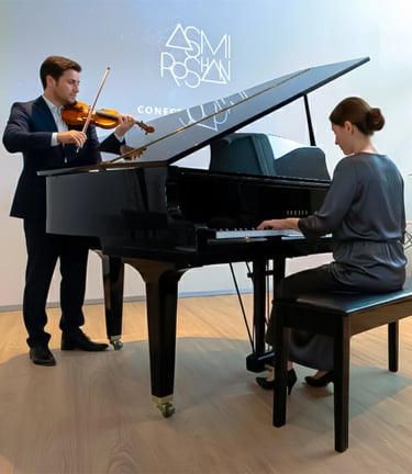 a man and woman playing a piano and violin