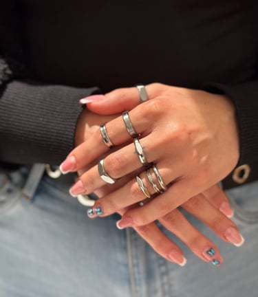 a woman's hands with rings on her fingers