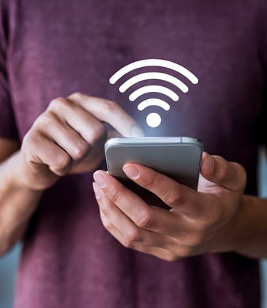 a man holding a cell phone looking for wifi connection
