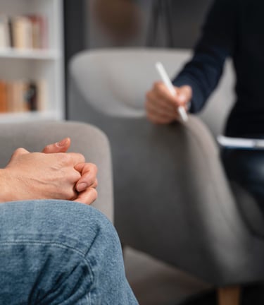 a man and woman sitting on a couch in a living room