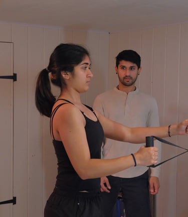 woman performing exercise, supervised by a trainer, to improve posture