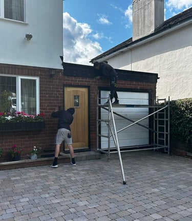 two men working on the front of a house in worcester